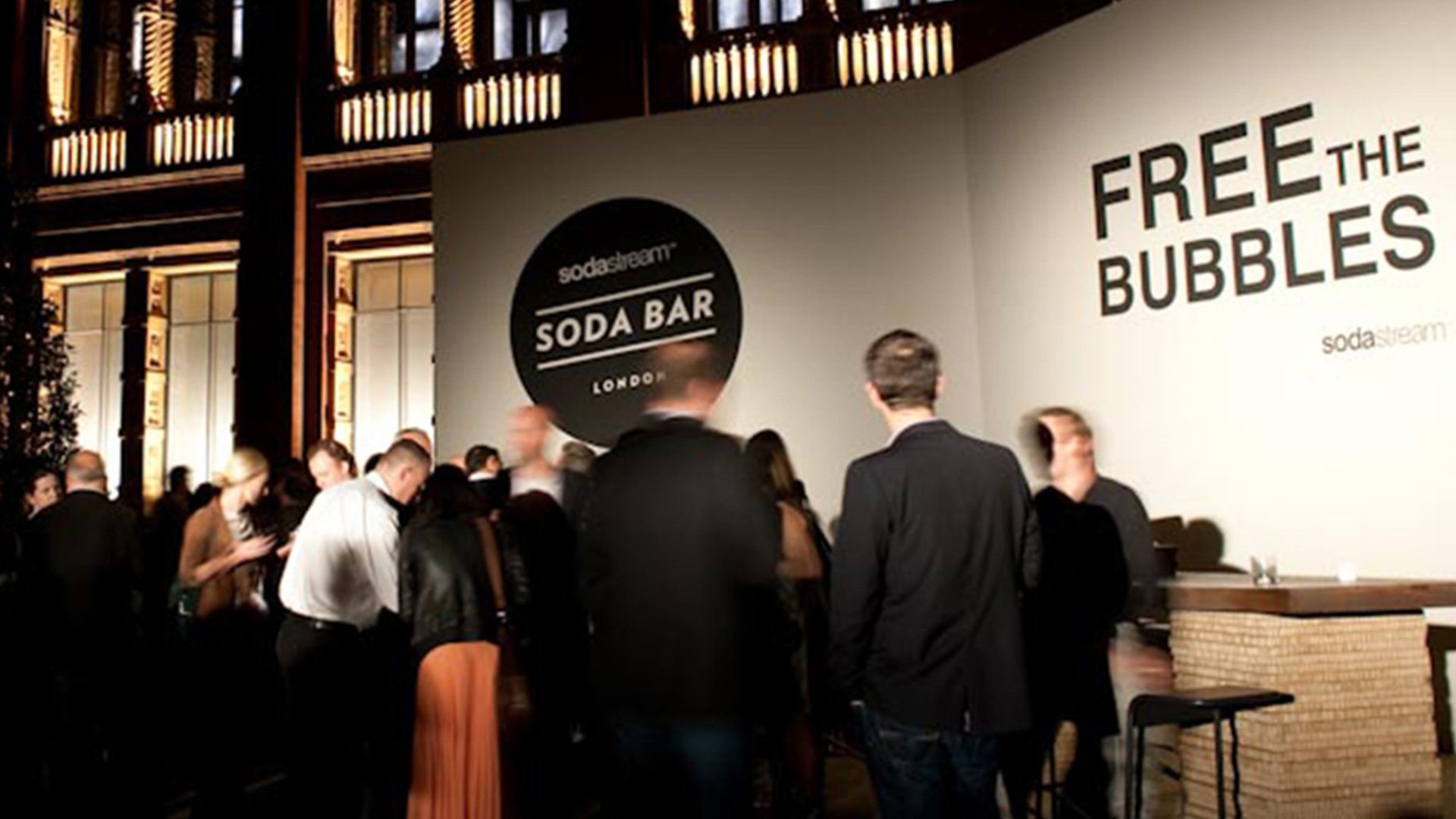 Black background with white 'FREE THE BUBBLES' sign and smaller 'SODA BAR' logo