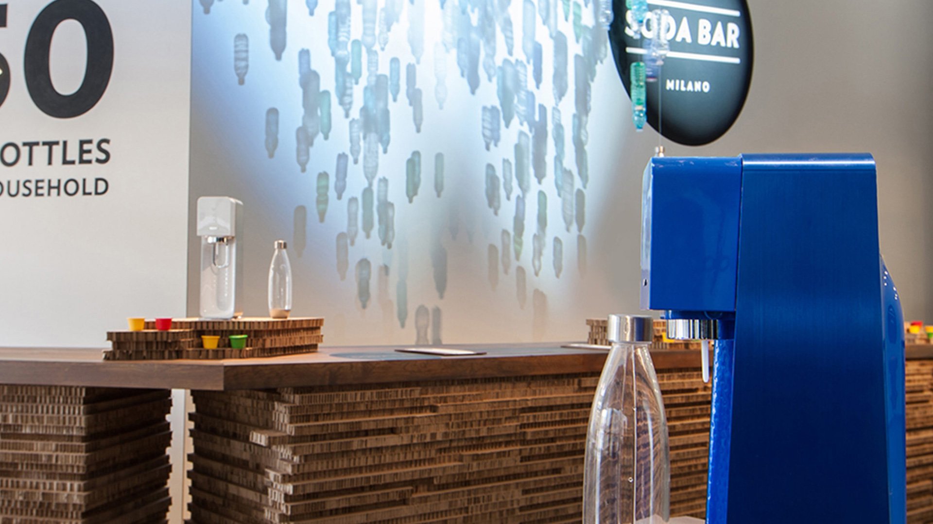 Counter with blue and white '100% recyclable' sign and menu board