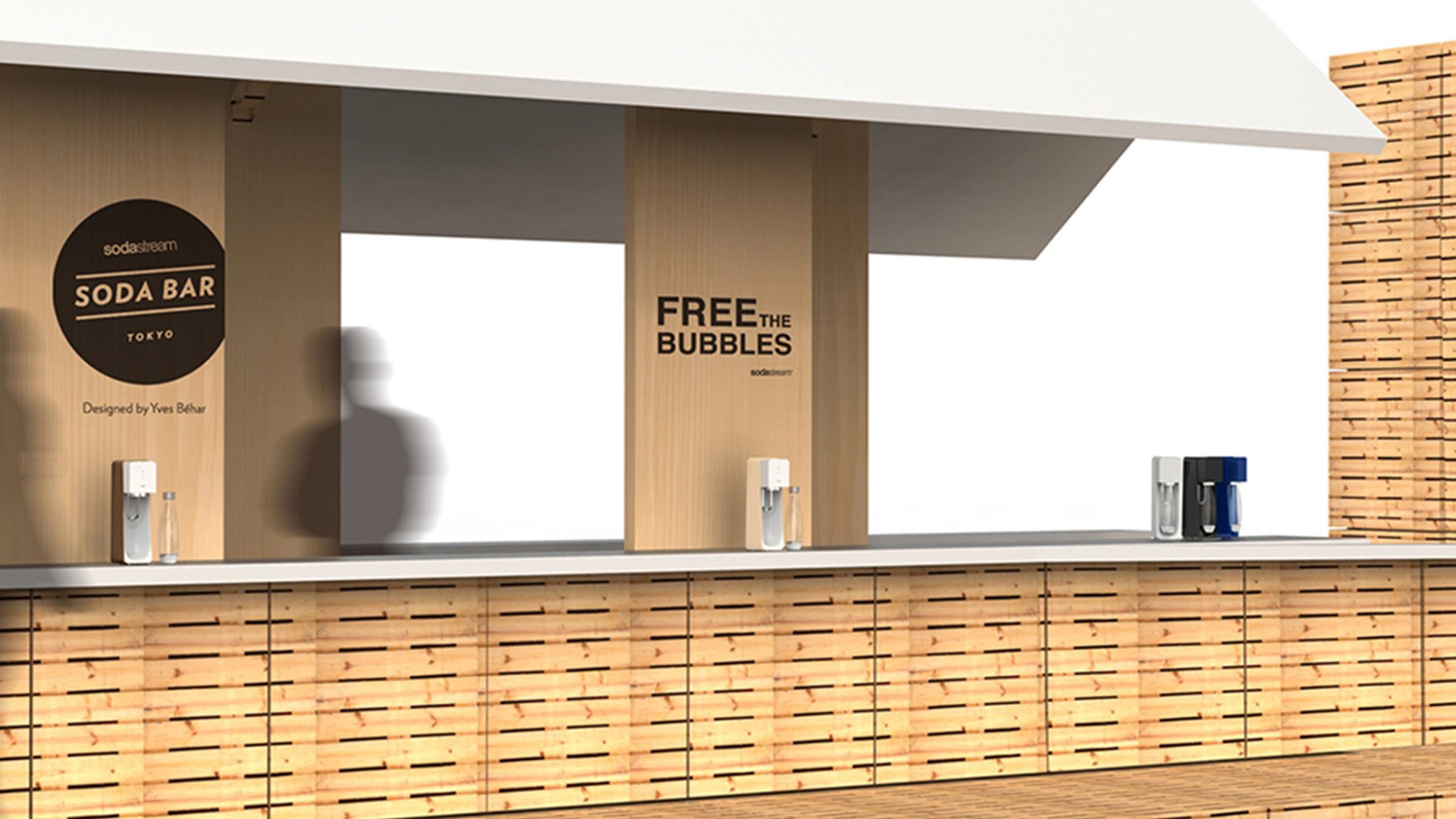 Wooden food stand with sign reading FREE SODA BAR and brick building