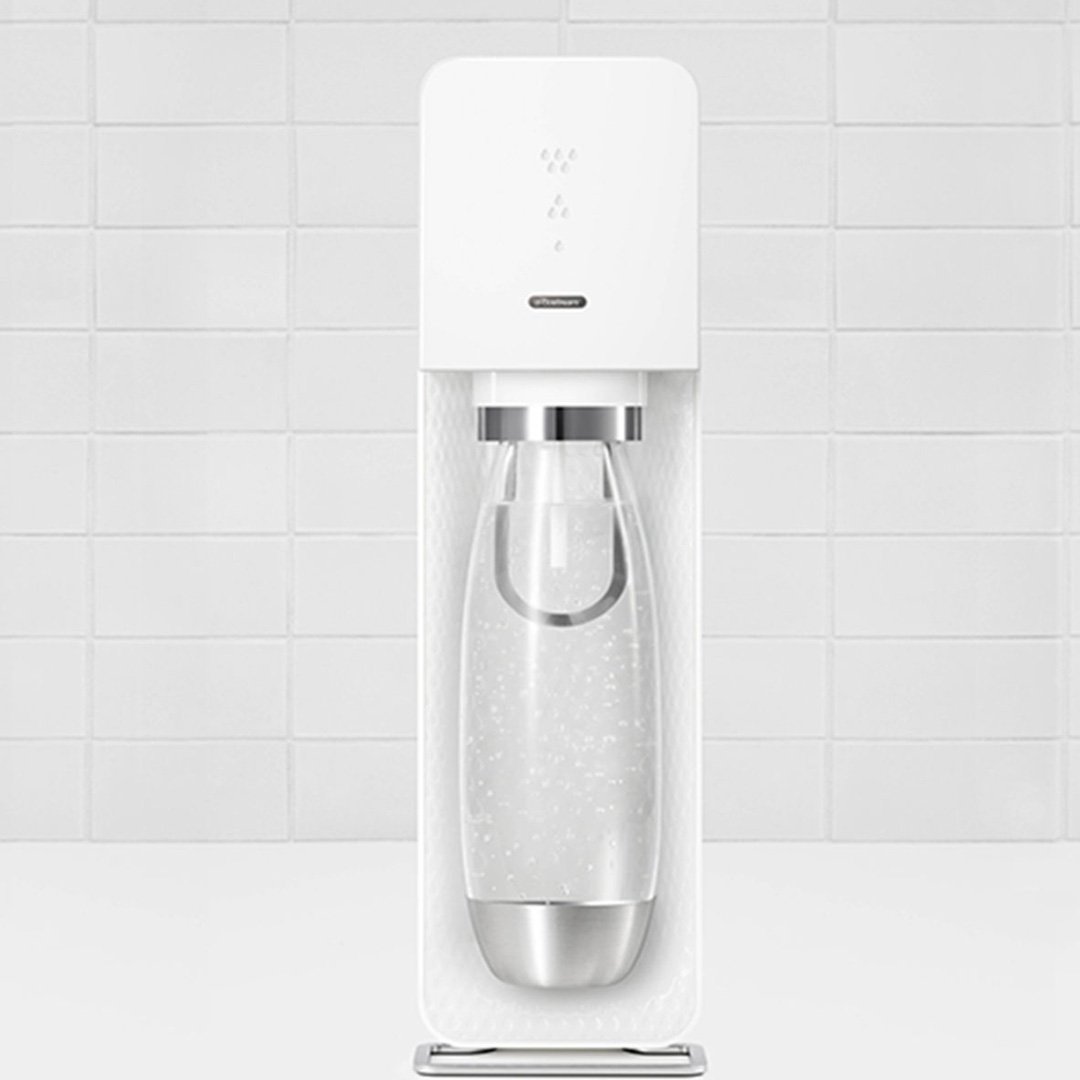 White countertop water dispenser with clear glass carafe and digital display