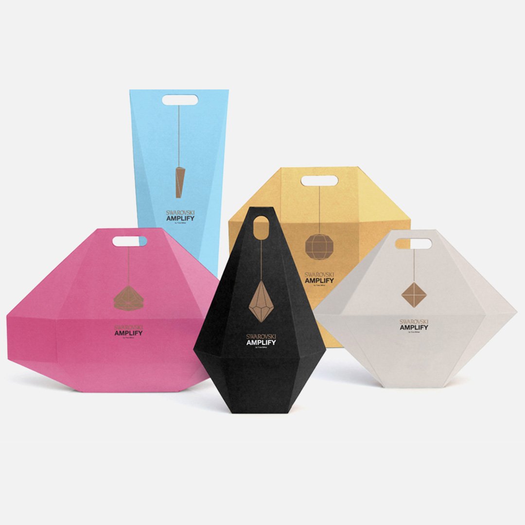 Colorful boxes with metallic compass rose designs on their surfaces