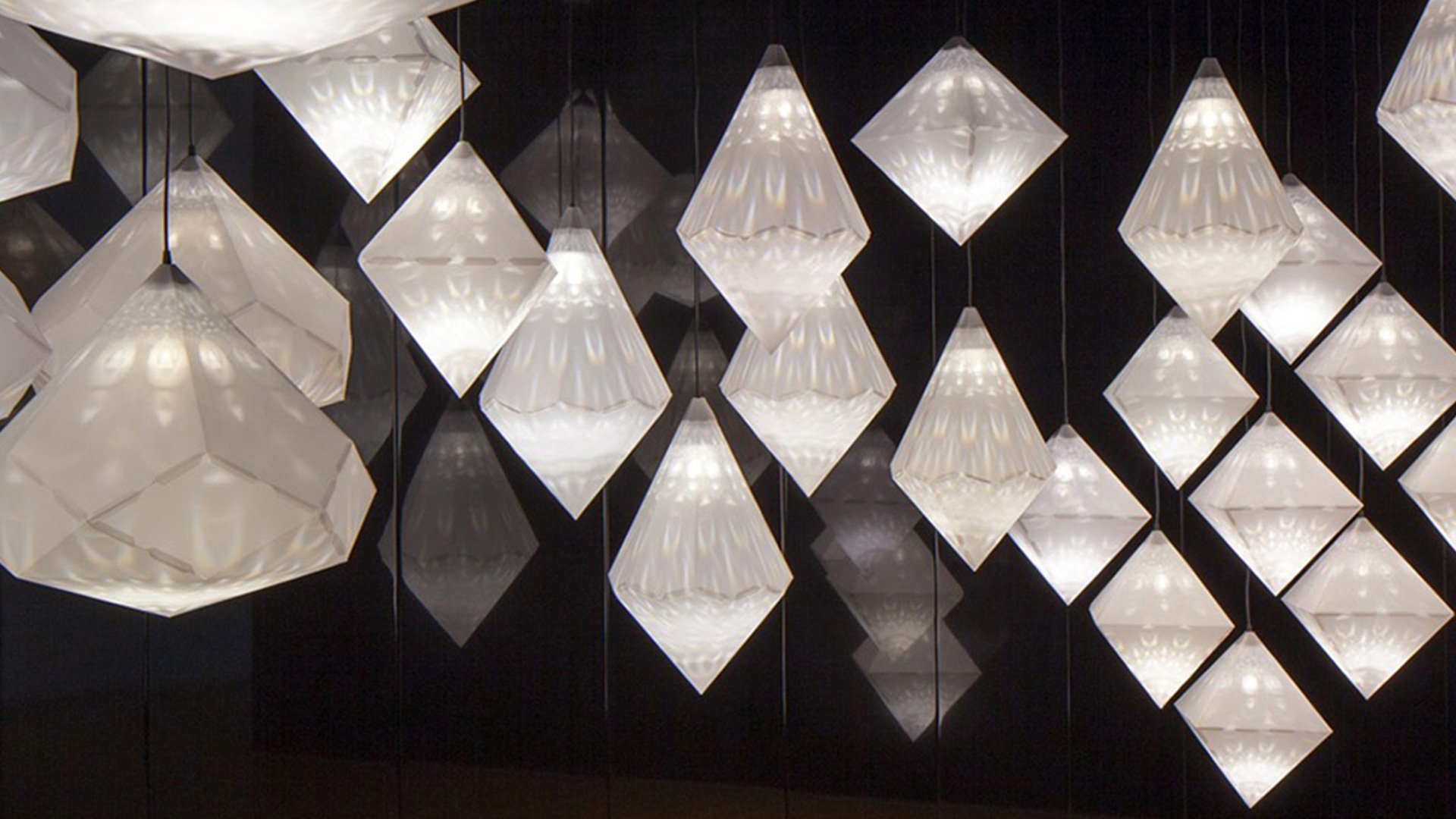 White light fixtures with patterns on dark background