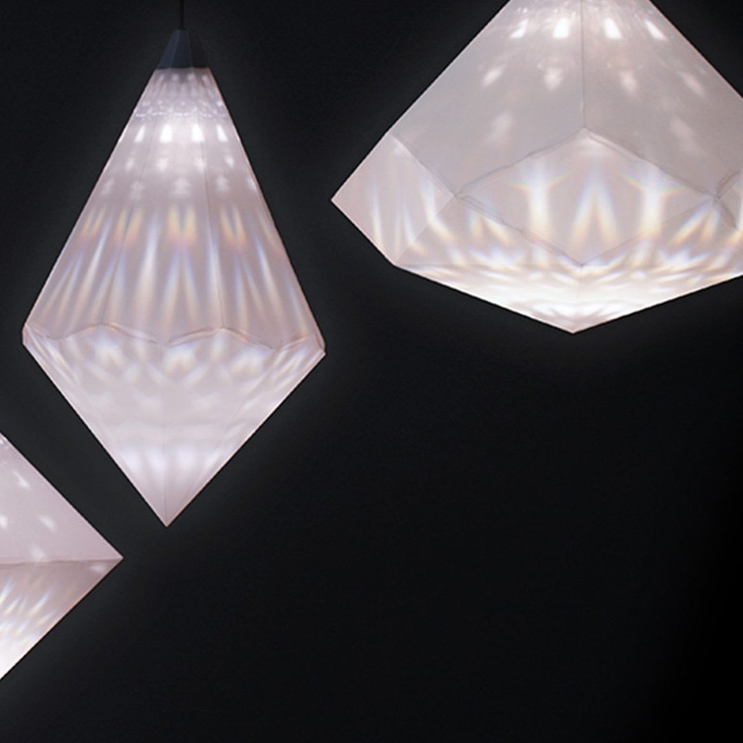 Geometric pendant lights in various shapes against a dark background