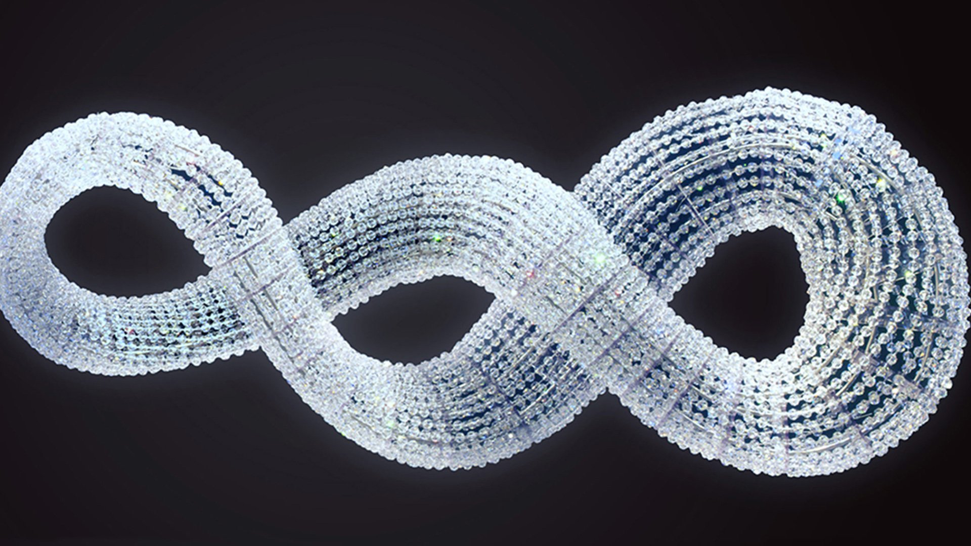Spiral pattern of white and blue lights on a dark background