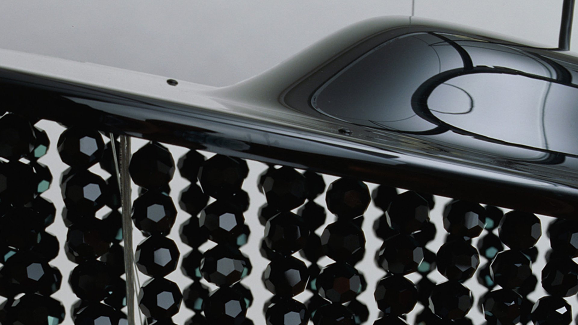 Black car with decorative grille and shiny surface