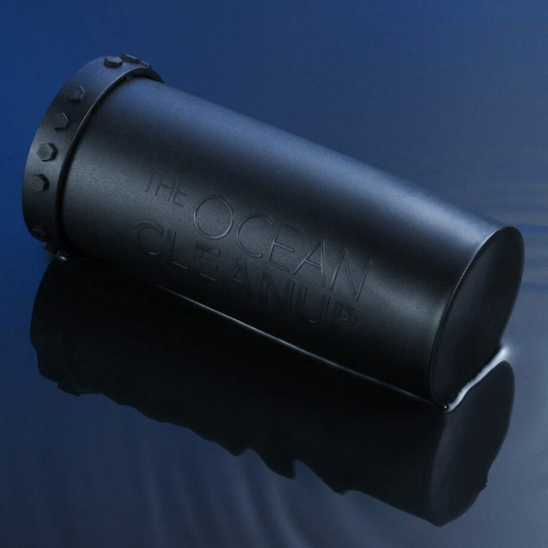 The Ocean Cleanup Sunglasses storage case: black cylindrical container with THE OCEAN CLEANUP text printed in white