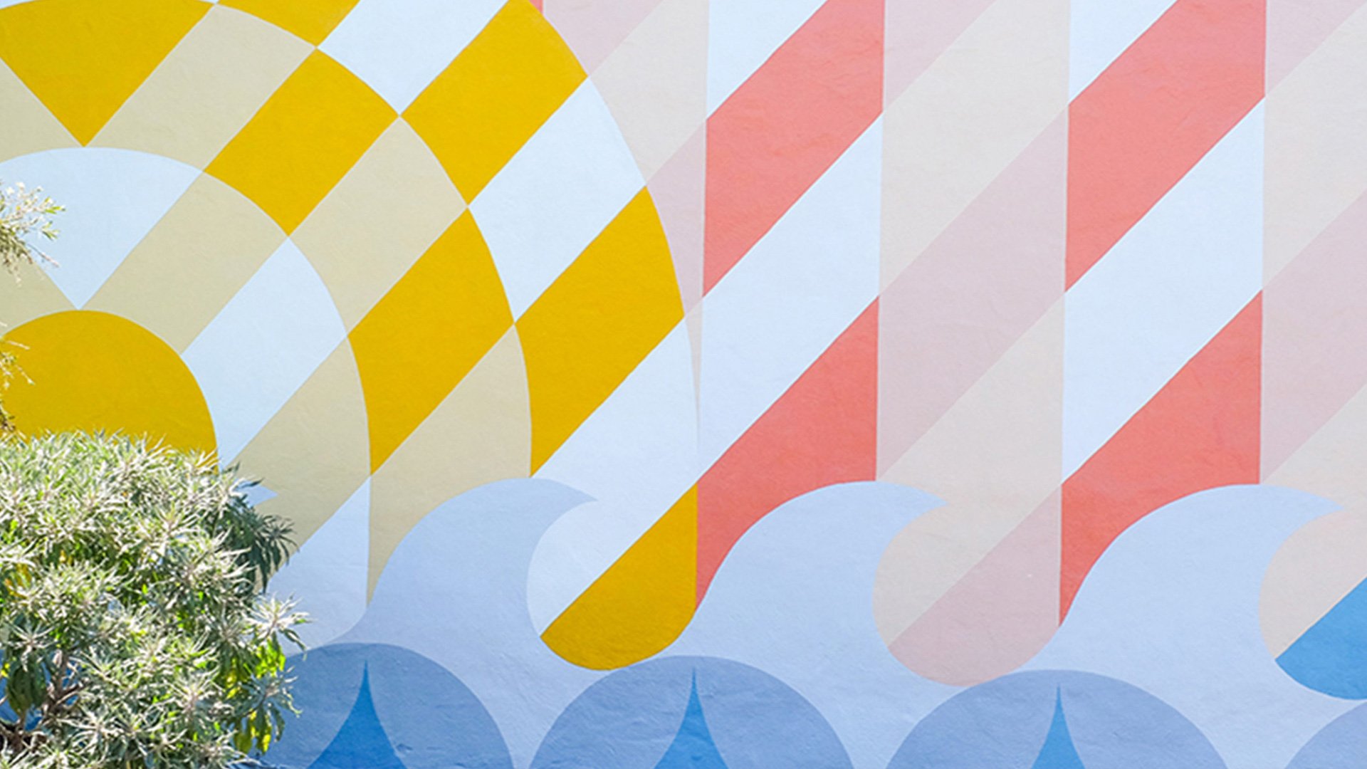 Close-up of Willie Mays Boys & Girls Club mural showing yellow sun rays, red and pink striped chevrons and blue ocean waves