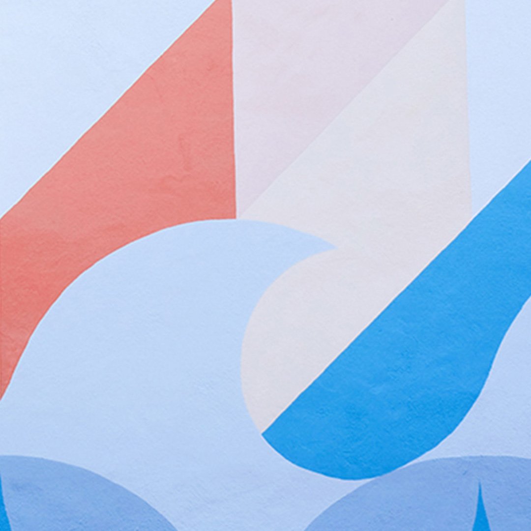 Abstract Willie Mays Boys & Girls Club mural detail: salmon and pink diagonals meeting pale blue circle and royal blue wave s