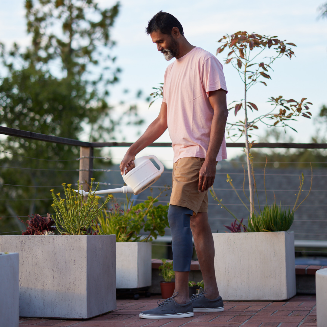 Man wearing CIONIC bionic leg gardening