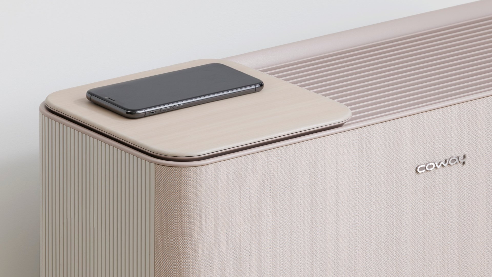 Coway air purifier with phone on top