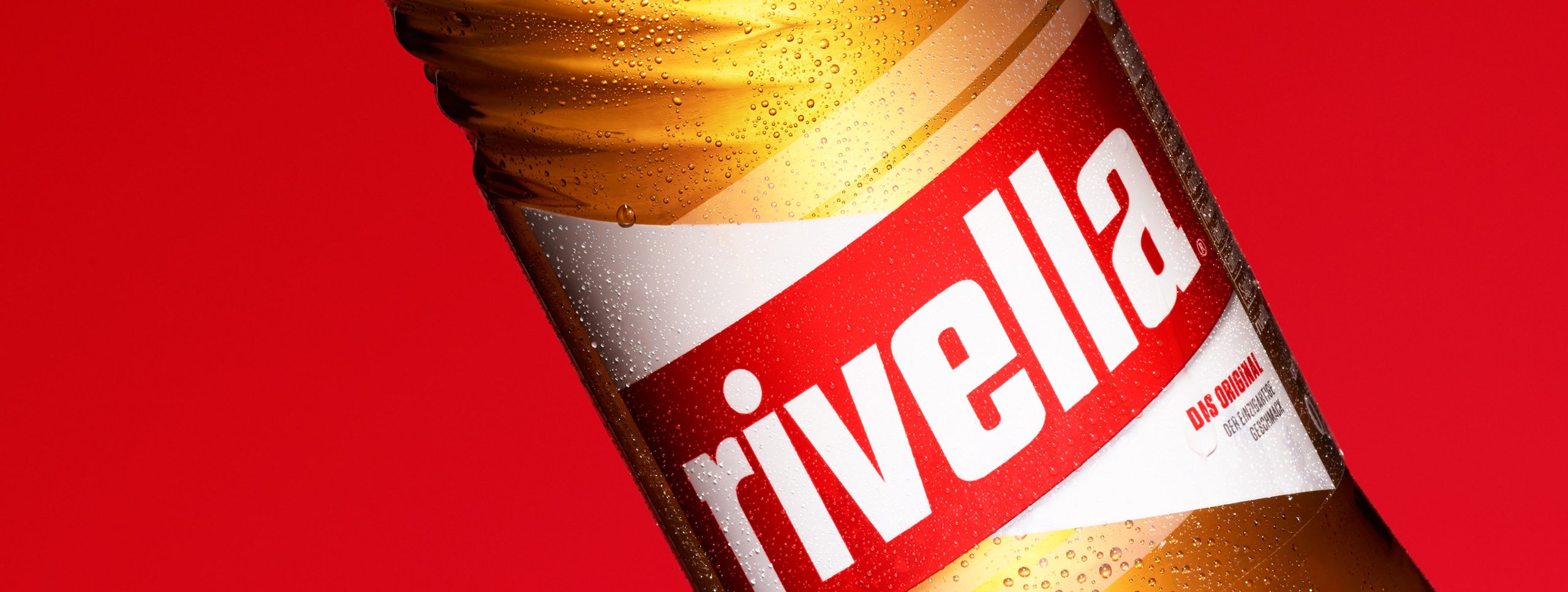 Rivella soda bottle on red background