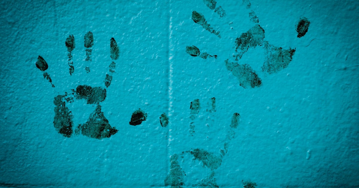 three hand prints on white wall