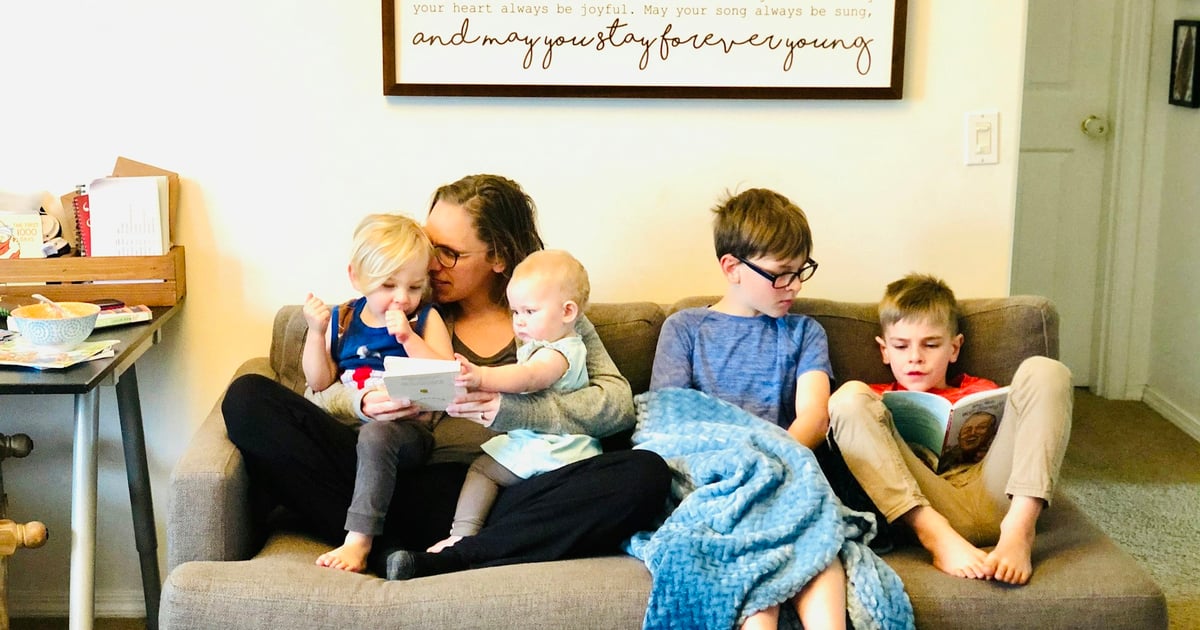 3 children sitting on gray couch