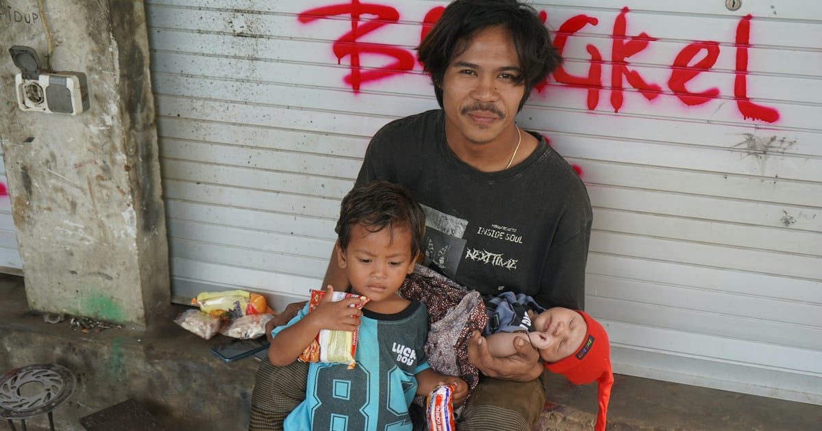 Man with two children sitting outside