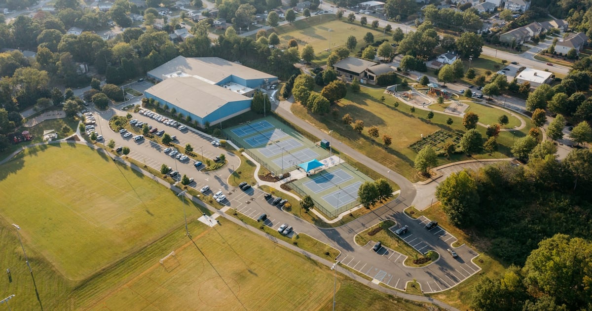 Aerial view of a sports complex with courts and fields.