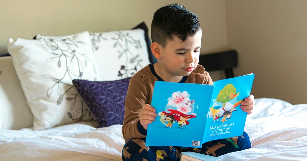 boy in blue and white crew neck t-shirt reading book