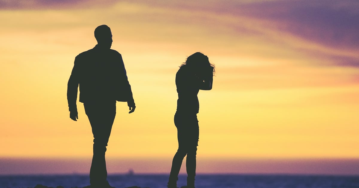 silhouette of man and woman under yellow sky