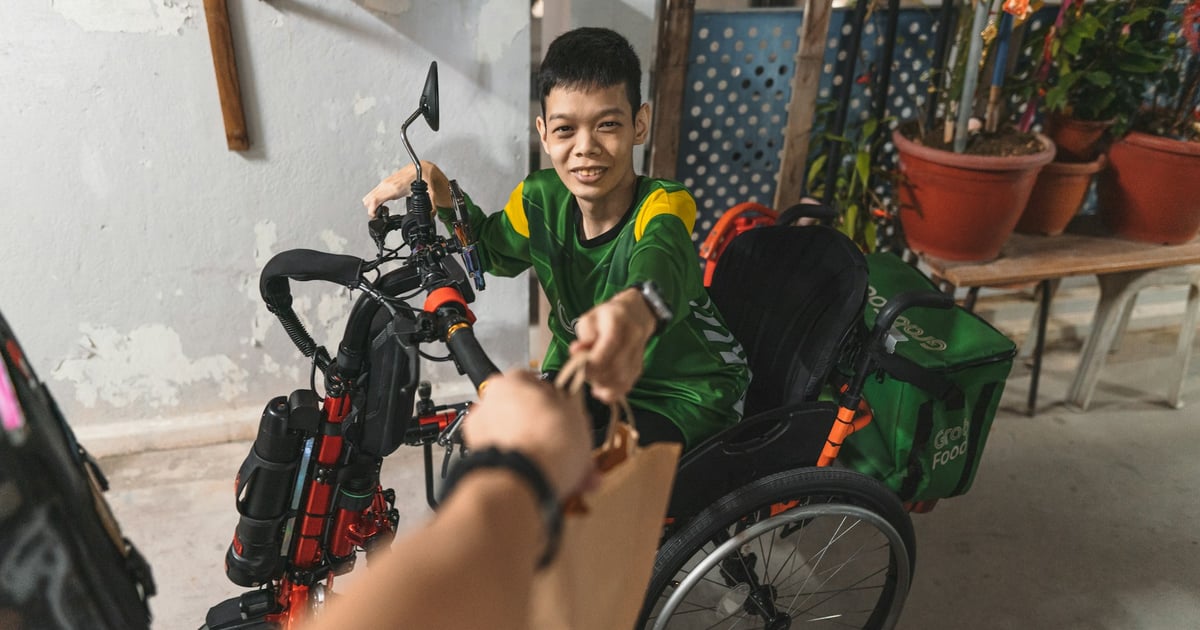 a boy in a green shirt sitting in a wheel chair