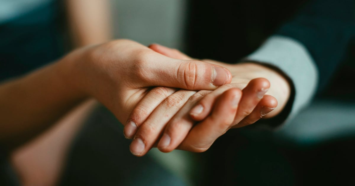 person holding babys hand