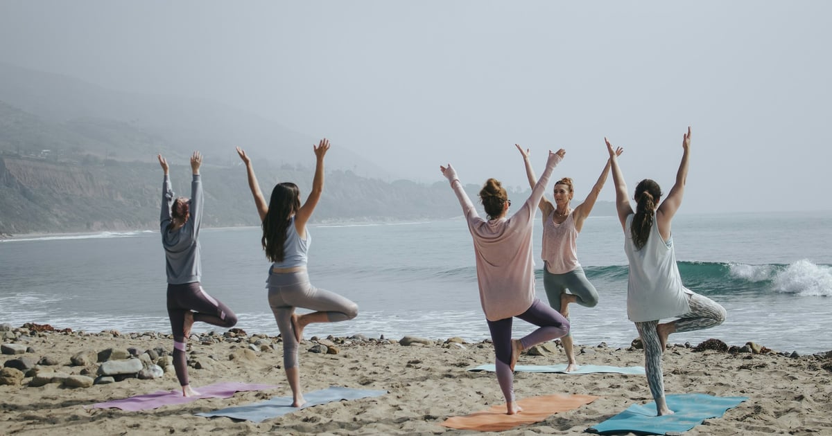 five woman standing on seashore