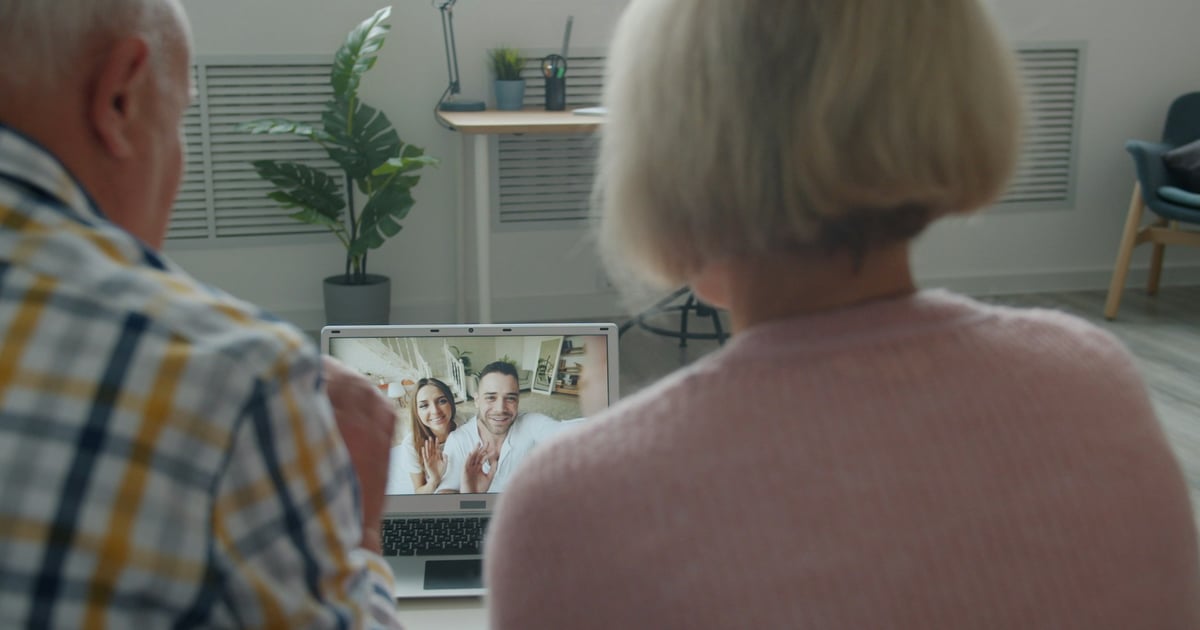 Elderly couple video calling with family at home