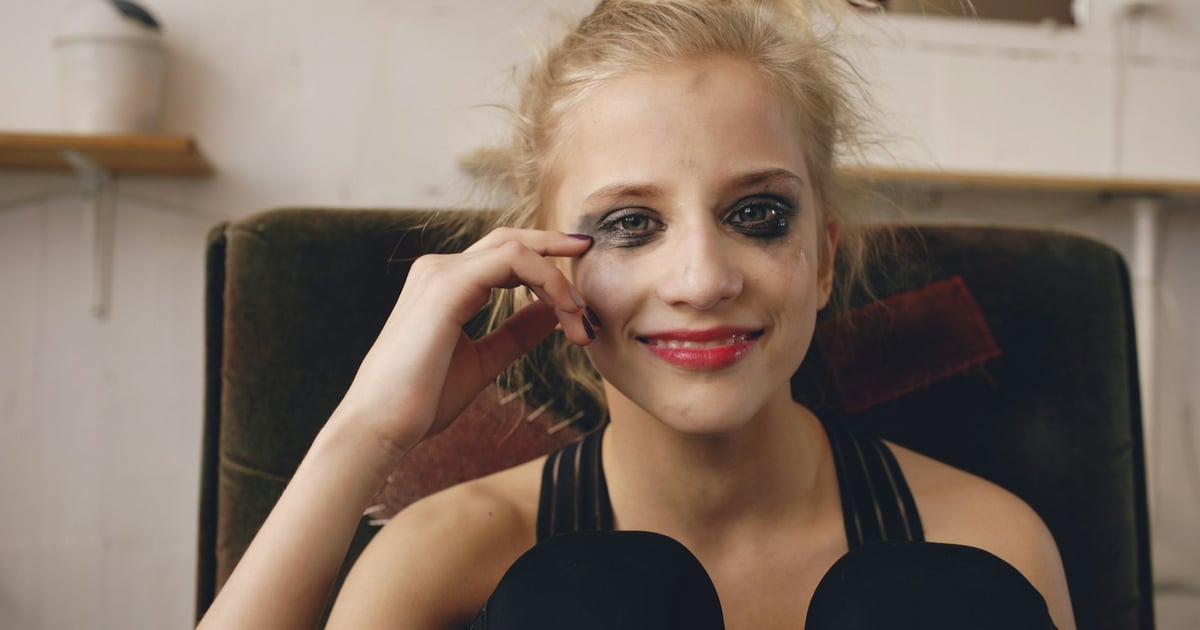 Young woman with smudged makeup smiles