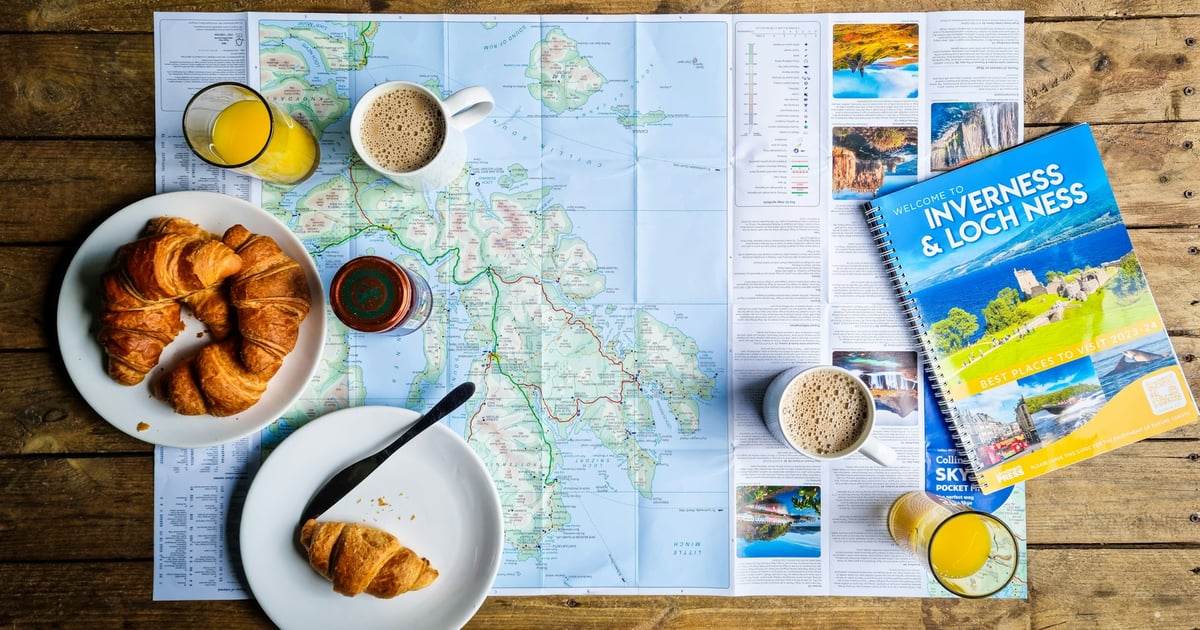 a map, a plate of croissants, a glass of orange juice