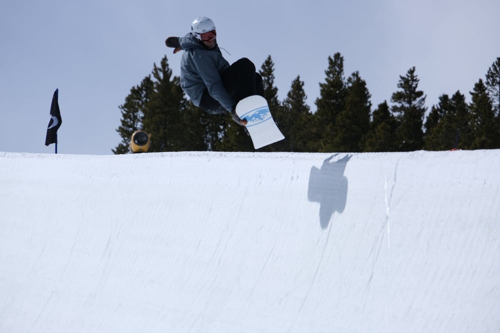 Andrew grabbing stalefish in Breck Freeway half‑pipe