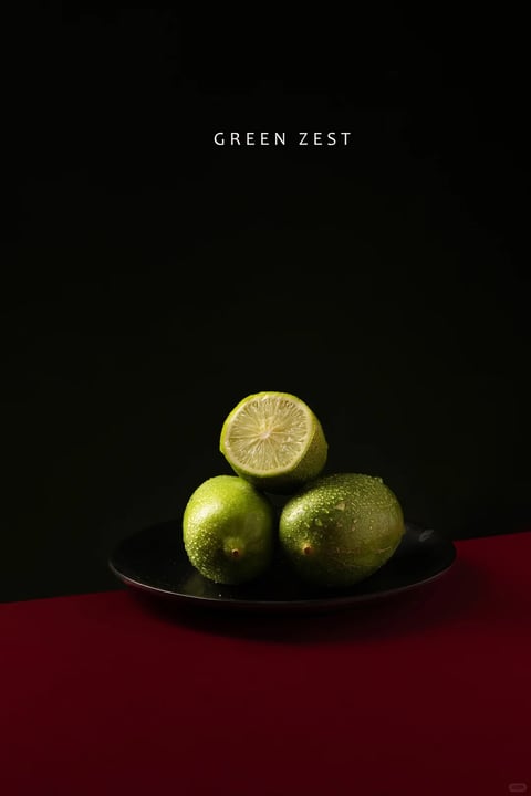 This image presents a photorealistic still life with a minimalist, high-contrast aesthetic. The color language is defined by a stark, limited palette: deep, saturated crimson red in the foreground surface, a matte black background and plate, and the vibrant, textured green of the limes. The lighting is dramatic and directional, appearing to come from the upper left, casting hard, defined shadows to the right and below the limes, which emphasizes their spherical volume and the wet, glossy texture of their skin. The composition is centered and balanced, with the limes arranged in a stable triangular formation on a shallow black plate, creating a clear focal point against the expansive negative space of the dark background. The texture is highly tactile, rendered with sharp detail to show the dimpled, porous surface of the lime rind and the glistening water droplets, contrasting with the smooth, matte finish of the plate and the flat, untextured color fields of the background and foreground. The overall mood is sophisticated, clean, and slightly moody, with a strong sense of visual weight and calm precision.