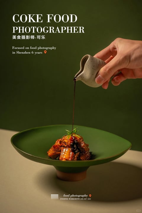 This image presents a photorealistic, high-end food photography style with a clean, minimalist aesthetic. The dominant color palette is a rich, muted forest green background contrasting with the warm, amber-brown tones of the glazed meat dish and the earthy beige of the tabletop, creating a sophisticated and grounded color language with moderate saturation and deep, defined shadows. Lighting is directional and dramatic, appearing to come from the upper left, casting soft but distinct shadows that emphasize the glossy texture of the sauce and the three-dimensional form of the food, conveying a moody, intimate atmosphere. The texture rendering is highly detailed and tactile, highlighting the sticky, viscous quality of the dark sauce being poured, the crispy edges of the meat, and the speckled, matte ceramic of the pitcher and plate. Compositionally, the image uses a centered, vertical arrangement with a shallow depth of field, focusing sharply on the food and pouring action while the hand and background gently soften, creating a strong focal point. Shape language combines the organic, irregular forms of the food with the smooth, geometric curves of the ceramic ware and the fluid, linear stream of sauce. The overall mood is elegant, appetizing, and artfully composed, evoking a sense of culinary craftsmanship and quiet indulgence.