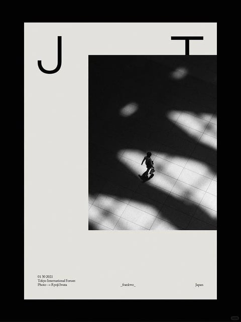 This image presents a minimalist, high-contrast black and white photographic composition with a graphic design overlay. The visual aesthetic is stark and modern, blending photorealistic street photography with flat, typographic elements. The color language is strictly monochromatic, utilizing a full range of values from deep, inky blacks to bright, clean whites, with no intermediate grays or color saturation. The lighting approach is dramatic and directional, featuring hard, geometric light patches cast onto a tiled floor, creating strong chiaroscuro effects and long, defined shadows that suggest a powerful, artificial light source from above. Texture and material feel are smooth and architectural; the floor appears as polished, reflective tiles, while the human figure is rendered as a dark, almost silhouetted form with minimal surface detail. Compositionally, the image is framed within a vertical poster format, with the photographic element offset to the right and partially obscured by large, bold sans-serif typography ('J' and 'T') in the upper section, creating an asymmetrical balance and a sense of layered depth. Shape language is predominantly geometric, defined by the rectangular frame, the grid of the floor tiles, and the sharp angles of the light and shadow, contrasted only by the organic, fluid form of the walking figure. The overall mood and atmosphere are contemplative, urban, and slightly enigmatic, evoking a sense of solitude within a vast, structured space.
