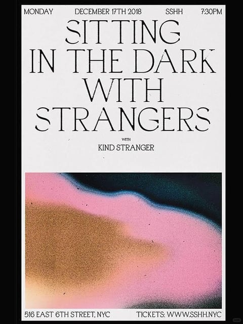 The image presents a poster with a distinct graphic design aesthetic, characterized by a stark, high-contrast layout. The upper half features bold, black serif typography on a clean white background, announcing 'SITTING IN THE DARK WITH STRANGERS' in a centered, hierarchical arrangement, with smaller text detailing the date, time, and location. Below this textual block, the lower half is dominated by an abstract, painterly image with a grainy, textured surface, reminiscent of a thermal scan or a distorted photographic print. This abstract section showcases a fluid, organic shape with a gradient of colors: a deep, shadowy teal-black at the top transitions into a vibrant, saturated pink, which then blends into a muted, earthy brown-gold at the bottom. The texture appears rough and speckled, suggesting a tactile, almost sandy or noisy quality. The composition is strictly divided horizontally, creating a sharp juxtaposition between the clean, geometric precision of the text and the amorphous, soft-edged forms of the abstract imagery. The overall mood is enigmatic and modern, balancing a clinical, informative tone with an evocative, mysterious visual element.