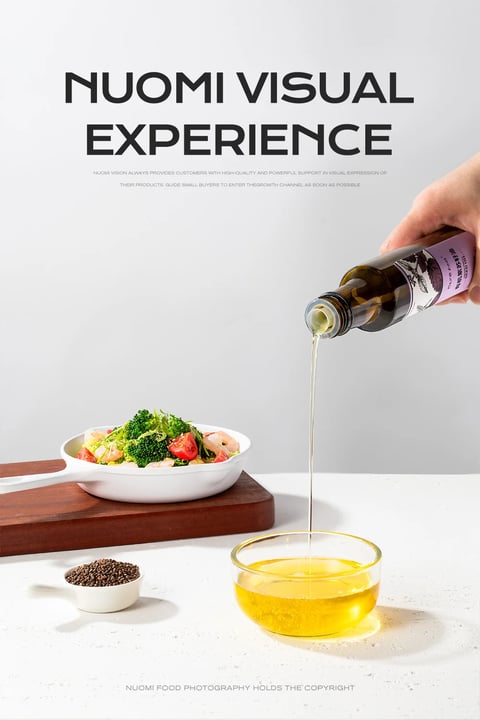 This image is a high-quality, photorealistic commercial food photograph with a clean, minimalist aesthetic, showcasing a bottle of oil being poured into a glass bowl, alongside a prepared dish and ingredients. The composition is arranged on a light, speckled white surface against a plain, light gray background, creating a bright and airy scene. The main subject is a dark glass bottle with a purple and white label, held by a hand entering from the upper right, pouring a steady, translucent stream of golden-yellow oil into a clear glass bowl in the lower right foreground. To the left, a white ceramic dish with a handle sits on a dark wooden board, containing a vibrant salad of broccoli florets, shrimp, and red tomato pieces. A small white ramekin filled with dark brown seeds or peppercorns is positioned in the lower left. The lighting is soft and diffused, appearing to come from the upper left, casting gentle, elongated shadows to the right and creating smooth highlights on the glass and ceramic surfaces, conveying a fresh and healthy mood. Visible text appears at the top in large, bold, black sans-serif font reading 'NUOMI VISUAL EXPERIENCE', with smaller descriptive text below it in English about providing high-quality visual support, and a copyright notice at the bottom stating 'NUOMI FOOD PHOTOGRAPHY HOLDS THE COPYRIGHT', all serving as branding and informational overlays. The focus is sharp throughout, with particular clarity on the pouring oil stream and the textures of the food, emphasizing the product's quality and the appetizing nature of the scene.