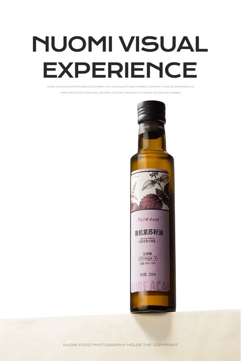 This is a studio product photograph of a single bottle of organic perilla seed oil, presented against a clean, minimalist white background with a subtle beige surface at the base. The composition is vertically oriented and centrally framed, with the tall, slender glass bottle as the sole focal point, creating a sense of elegant simplicity and commercial clarity. The bottle is made of dark amber glass, filled with a translucent golden-yellow oil, and topped with a matte black screw cap. Its label features a botanical illustration of a perilla plant with detailed leaves and stems in muted purple and green tones, set against a soft lavender background. The overall visual aesthetic is photorealistic with a clean, high-end commercial style, emphasizing product purity and quality. The color language is dominated by the warm amber of the oil, the cool lavender of the label, and the stark contrast of black text and cap against the white backdrop, with a balanced, neutral color temperature. Lighting is soft and directional from the front-left, creating gentle highlights on the glass shoulder and a subtle shadow to the right, conveying a calm, natural mood. Texture and material feel are rendered with precision: the smooth, reflective glass, the matte paper label with fine printed details, and the viscous, liquid quality of the oil are all clearly tactile. The composition uses negative space effectively to isolate the product, with depth created by the bottle's shadow on the beige surface. Shape language combines the organic curves of the bottle and botanical illustration with the geometric lines of the label layout and typography. The mood is serene, premium, and health-focused, with a low-energy, contemplative atmosphere. Visible text includes the brand name "Pure Acci" in a stylized script at the top of the label, followed by the product name in Chinese characters "有机紫苏籽油" (Organic Perilla Seed Oil) and English "ORGANIC PERILLA SEED OIL". Below, it specifies "亚麻酸 Omega-3" with a content range of "含量:60%-70%" and the net volume "净含量: 250ml". At the top of the image, large black sans-serif text reads "NUOMI VISUAL EXPERIENCE", with smaller supporting text below describing the visual service. At the bottom, a copyright notice states "NUOMI FOOD PHOTOGRAPHY HOLDS THE COPYRIGHT". The text is primarily in English and Chinese, serving branding, informational, and copyright roles. The focus is sharply on the bottle and its label details, with the background intentionally soft and unobtrusive to direct all visual attention to the product.