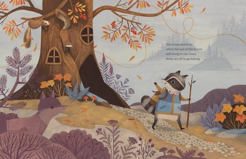 The image is a whimsical, illustrative scene rendered in a soft, painterly style with a textured, almost paper-like finish. The composition centers on a large, stylized tree trunk on the left, featuring small, round windows that suggest a dwelling, with two squirrels perched on its branches. In the foreground, a fox with muted purple fur sits among low-lying, similarly hued foliage. To the right, the main subject, a raccoon named Holly, is depicted mid-stride on a pebbled path, wearing a blue patterned vest and carrying a walking stick, waving with one paw. The background reveals a misty, layered landscape of distant evergreen trees and hills under a pale, overcast sky. The color palette is dominated by muted, earthy tones—soft purples, dusty blues, warm ochres, and terracotta oranges—with low saturation and gentle contrast, creating a cool, autumnal atmosphere. The lighting is diffuse and soft, with no harsh shadows, evoking a calm, crisp morning. Text appears in the upper right quadrant, reading: 'One crisp morning, when the last of the leaves still clung to the trees, Holly set off to go hiking.' The text is in a classic serif font, integrated into the scene's negative space, serving a narrative role. The overall aesthetic combines organic, rounded shapes with fine, delicate linework for details like fur and foliage, and the mood is serene, adventurous, and gently nostalgic.
