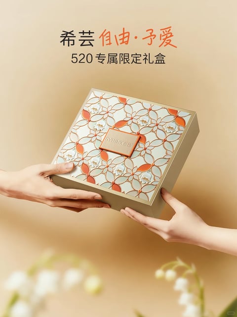 The image features a central, elegant square gift box held by two hands against a softly blurred, warm-toned background, creating a balanced and intimate composition. The box is the main subject, rendered with a photorealistic 3D quality, showcasing a lid with a complex, raised geometric and floral pattern in a palette of white, terracotta orange, and metallic gold lines. A rectangular, textured leather-like tag with the debossed text "SYRINX 希芸" is affixed to the center of the lid. Visible text at the top of the image, in a mix of black and warm orange characters, reads "希芸 自由·予爱" and "520专属限定礼盒", identifying the brand and the product as a limited-edition gift box. The lighting is soft and directional from the upper left, casting gentle shadows that enhance the three-dimensional texture of the box's intricate pattern and the subtle sheen of its gold edges. The overall color language is warm and sophisticated, dominated by creamy beiges, terracotta, and gold, with low contrast and a warm color temperature that evokes a feeling of luxury and affection. The texture is highly detailed, contrasting the smooth, matte finish of the box's base with the raised, glossy and matte elements of the decorative lid pattern. The composition uses a shallow depth of field to keep the hands and box in sharp focus while blurring the background and foreground elements (like out-of-focus white flowers), guiding the viewer's eye directly to the act of gifting. The mood is one of gentle, celebratory warmth and refined elegance.