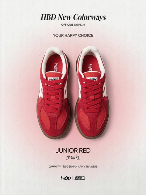 The image is a promotional poster for a new colorway of sneakers, featuring a pair of red athletic shoes as the central subject against a soft, textured background. The composition is symmetrical and clean, with the shoes placed side-by-side in the center, viewed from a top-down perspective, creating a balanced and focused layout. The visual aesthetic is a blend of photorealistic product photography with a subtle, textured overlay that gives it a slightly vintage or crafted feel. The color language is dominated by a vibrant, saturated red (the 'Junior Red' of the shoes), contrasted sharply with white accents on the heel and side stripes, and grounded by a dark brown sole. The background is a pale, off-white with a gentle pinkish gradient wash behind the shoes, enhancing their prominence. Lighting is soft and diffused, coming from above, casting minimal, gentle shadows beneath the shoes and highlighting the suede and mesh textures without harsh glare, creating a clean, approachable mood. The texture and material feel are distinctly tactile: the shoes display a mix of soft, napped suede on the overlays, breathable mesh on the toe box, and smooth synthetic materials for the white accents, all rendered with clear surface detail. Visible text includes the headline 'HBD New Colorways' in a bold, elegant serif font at the top, followed by smaller sans-serif text 'OFFICIAL LAUNCH' and 'YOUR HAPPY CHOICE.' Below the shoes, the text 'JUNIOR RED' and its Chinese translation '少年红' appear, with 'DAWN SERIES 180 GERMAN ARMY TRAINERS' in smaller type, and the logos 'HBD' and 'Dawn80' at the very bottom; all text is in black, serving an informative and branding role. The shape language is a mix of the shoes' organic, curved lines and structured geometric panels, with clean, defined edges. The overall mood and atmosphere are energetic yet polished, evoking a sense of youthful vibrancy and casual style.