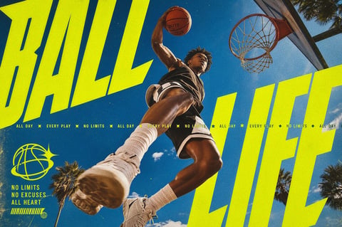 This image is a dynamic, photorealistic sports photograph capturing a male basketball player mid-air, executing a dunk. The composition is a low-angle shot looking up at the athlete against a vibrant blue sky with sparse white clouds and palm tree tops at the edges. The player, with dark hair and skin, wears a black sleeveless jersey and shorts with white trim, white crew socks, and white sneakers. His right arm is extended upward, gripping an orange basketball labeled 'ELITE', while his left leg is thrust forward toward the viewer, creating a powerful sense of motion and depth. Dominating the frame are large, bold, slanted typography elements in a fluorescent lime-yellow color. The word 'BALL' is positioned in the upper left, and 'LIFE' in the lower right, framing the central action. A horizontal band of smaller text in the same color reads 'ALL DAY ✪ EVERY PLAY ✪ NO LIMITS ✪' repeated across the middle. In the lower-left corner, a logo of a stylized globe with a starburst sits above the stacked phrases 'NO LIMITS', 'NO EXCUSES', 'ALL HEART'. The visual aesthetic is high-contrast and energetic, with a saturated color palette dominated by the electric yellow text, deep sky blue, and the warm brown tones of the player's skin and basketball. The lighting is bright, direct sunlight, casting sharp, defined shadows on the player's musculature, emphasizing texture and form. The texture is crisp, with the grain of the basketball, the knit of the socks, and the fabric of the uniform clearly rendered. The composition uses strong diagonal lines and overlapping shapes to create a sense of upward momentum and intense athletic energy, with a mood that is motivational, bold, and full of vitality.