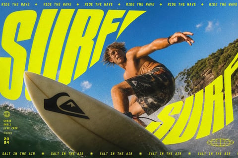 This is a high-energy, dynamic lifestyle image centered on a shirtless male surfer in mid-action on a wave. The composition is a low-angle close-up, placing the viewer near the water's surface, with the large, off-white surfboard dominating the lower-left foreground. The surfer, positioned center-right, is captured in a crouched, athletic pose with his left arm extended for balance, creating a strong diagonal line. His tanned skin and wet, blonde hair are sharply detailed. The background features a vibrant blue sky with a few wispy clouds and a rocky, green-covered cliffside in the upper right. The image employs a distinct visual aesthetic that blends photorealistic photography with bold, graphic design elements. The color language is highly saturated and high-contrast, with dominant tones of electric yellow, deep oceanic teal, and the vibrant blue of the sky, all given a slightly grainy, filmic texture. The lighting is hard, direct sunlight, creating strong highlights on the surfer's skin and the water spray, and casting sharp shadows, which emphasizes the intense midday energy. The texture and material feel are richly tactile, from the smooth, matte finish of the surfboard and the glossy sheen of the wet board shorts to the frothy spray of the water and the gritty grain of the overall image. The composition is dynamic and crowded, using a forced perspective that makes the surfboard and text feel immense, with depth created by the sharp focus on the foreground elements against the slightly softer background. The shape language combines the organic, fluid forms of the surfer and waves with the bold, geometric, and slanted sans-serif letterforms that slice across the image. The overall mood and atmosphere are one of adrenaline, freedom, and intense summer energy, conveying a sense of action and coastal vitality. Extensive text is integrated as a major design element: the word 'SURF' in enormous, slanted, neon-yellow block letters appears twice, once in the upper left and once in the lower right, framing the action. A repeating header banner at the very top reads 'RIDE THE WAVE' in a smaller, matching yellow font, separated by plus signs. In the lower left corner, smaller yellow text lists 'CHASE', 'SNELL', 'LIVE FREE' stacked vertically, with a globe icon above and a '2024' date below. A wavy line icon separates these. The bottom edge features a repeating footer banner that reads 'SALT IN THE AIR' in the same small yellow font, separated by star icons, with another wireframe globe graphic on the right.