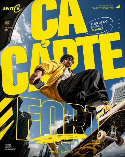 This is a dynamic, photorealistic lifestyle advertisement image with a graphic design overlay. The main subject is a young man with dark curly hair, wearing reflective sunglasses, a yellow satin bomber jacket over a white shirt, and black pants, captured mid-motion while performing a trick on a skateboard. The composition is a dramatic low-angle shot, looking up at the subject against a backdrop of a bright blue sky with scattered white clouds and the silhouettes of modern city skyscrapers. Large, bold yellow text dominates the foreground, partially obscuring the scene. The text reads 'ÇA CARTE FORT' (French for 'That's a strong card' or a play on words for a strong network), with 'ÇA' and 'CARTE' in solid yellow block letters and 'FORT' outlined in yellow. Additional text appears in the top corners: 'SWITCH' (a logo), 'RÉSEAU 5G', and 'CHEZ SWITCH ON RESTE CONNECTÉ', along with a speech bubble stating 'PLUS DE GO MOINS DE BLA-BLA'. The visual aesthetic combines high-energy, urban street style with bold commercial typography. The color language is defined by a high-contrast palette of vibrant primary yellow, deep blue sky, and black clothing, creating a saturated and energetic feel. The lighting is bright, hard daylight, casting sharp shadows and creating strong highlights on the subject's jacket and the skateboard. Textures are clearly rendered, from the smooth sheen of the jacket and the metallic skateboard trucks to the denim of the pants. The composition uses a forced perspective with the skateboard and subject looming large in the frame, creating significant depth. The shape language juxtaposes the organic forms of the person and clouds with the rigid geometric shapes of the buildings and typography. The overall mood is one of youthful energy, urban freedom, and bold confidence, conveying a sense of movement and connectivity.