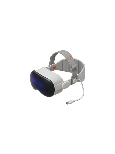 This image features a standalone virtual reality headset presented against a pure, featureless white background, creating a clean, product-focused composition. The headset has a sleek, modern aesthetic with a smooth, matte white plastic body and a contrasting glossy black front visor that exhibits a subtle blue-to-purple iridescent sheen under the light. The headband is a flexible, light gray fabric strap with visible vertical ribbing and small orange accent details, including a rectangular tag and stitching along the inner edge. A single white cable with a USB-C connector extends from the side. The lighting is soft and diffuse, casting gentle shadows that define the headset's curved forms without creating harsh contrasts, emphasizing its smooth surfaces and ergonomic design. The overall color palette is dominated by whites, grays, and blacks with minimal orange accents, resulting in a neutral, high-tech visual tone. The rendering is photorealistic, highlighting material differences between the matte plastic, glossy visor, and woven fabric strap. There is no visible text or branding on the product itself.