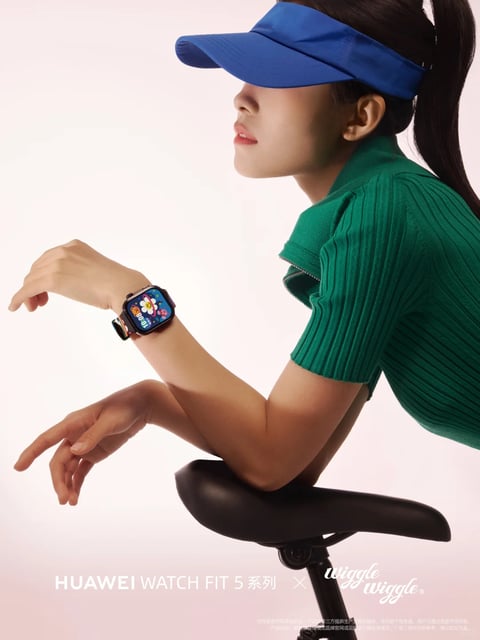 The image features a woman in a side-profile pose against a soft pink gradient background, showcasing a smartwatch on her left wrist. She wears a vibrant blue sun visor and a form-fitting, ribbed emerald green short-sleeve top, with her hair tied back in a ponytail. Her left arm is bent at the elbow, resting on a black bicycle saddle, positioning the watch prominently. The watch itself has a square, dark metal case with rounded corners and a colorful, patterned fabric strap; its screen displays a whimsical floral and star design with a digital time readout. Text at the bottom reads 'HUAWEI WATCH FIT 5 系列 × wiggle wiggle' in a mix of sans-serif and script fonts, indicating a product collaboration. The overall style is realistic and commercial, with clean lighting that highlights the textures of the ribbed fabric and the glossy screen of the watch. The composition uses the woman's posture and the bicycle saddle to create dynamic lines that draw attention to the wearable device, implying an active, lifestyle-oriented context.