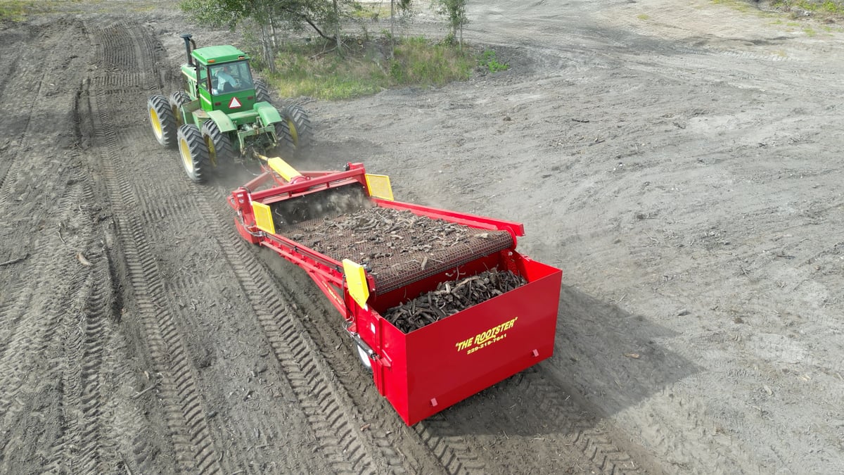 The Rootster being pulled through a field.