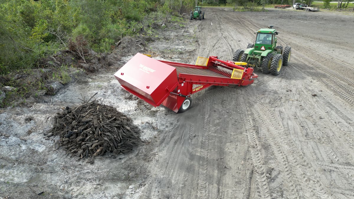 The Rootster dumping its hopper.