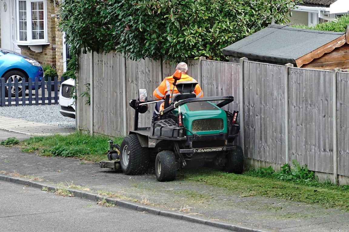 Ride-on mower cutting grass for a housing association