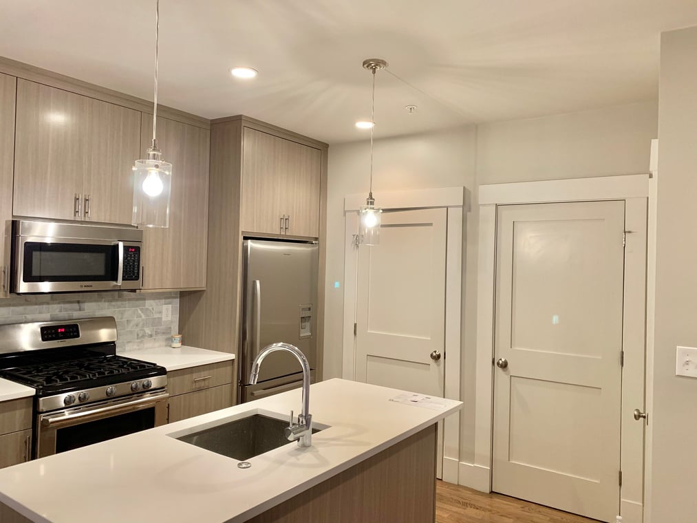 Exterior deck refinished by Cape Cod Fine Finishes LLC in Massachusetts. The rich wooden boards contrast with the weathered gray shingles, highlighting the company’s quality restoration work.