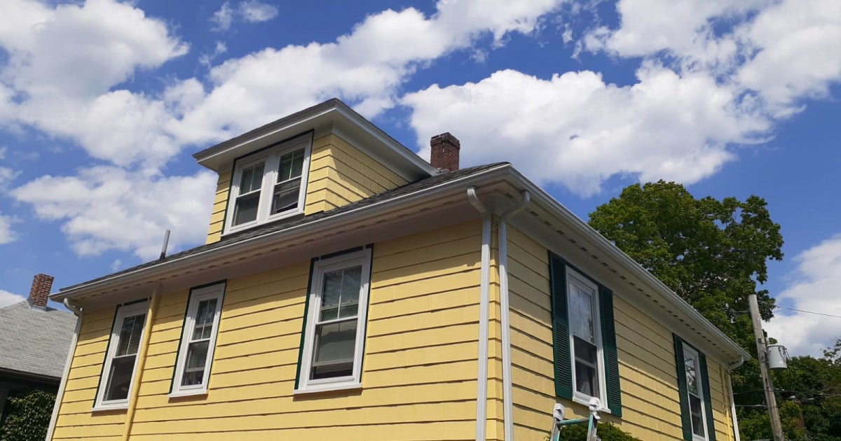 This is an image from Méndez Painters Inc, located in Massachusetts. The company logo features stylized rooftops with a spray paint gun icon, highlighting their expertise in residential and commercial painting services.