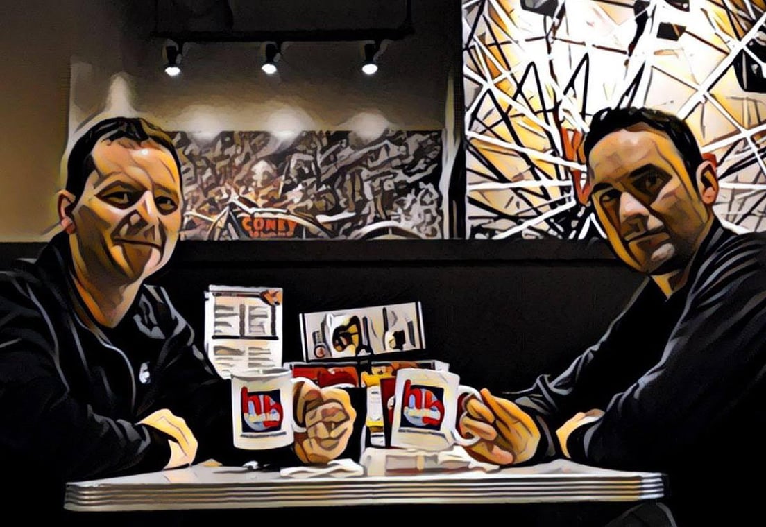This is an image from Hillis Brothers Painting company, located in Kentwood, MI The image is a Hillis Brothers Painting team members holding branded HB Painting coffee mugs at a diner table