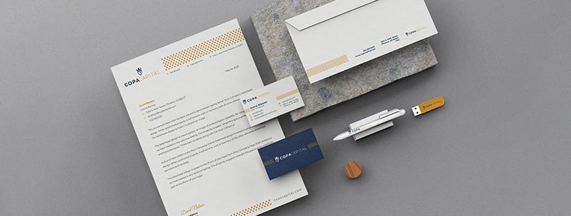 mockup of business stationery including letterhead, business cards, an envelope, and pen.