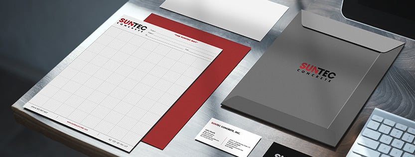 business stationery for Suntec Concrete displayed on a computer desk.